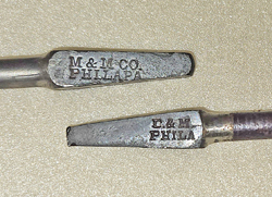 arrow atop hinged bit holder