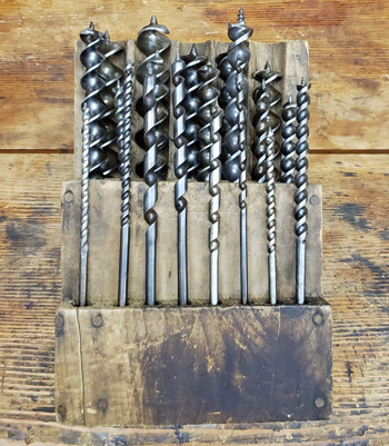 assorted auger bits in homemade box